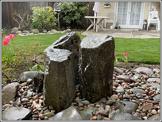 Water feature in a yard running on low voltage irrigation