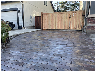 Fence installed on top of brick driveway