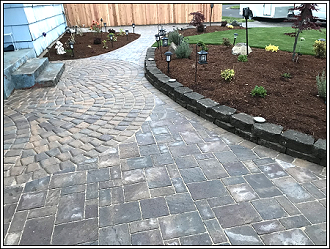 Brick hardscape walkway beside flower beds