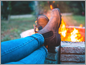 Feet kicked up while relaxing at a fire pit